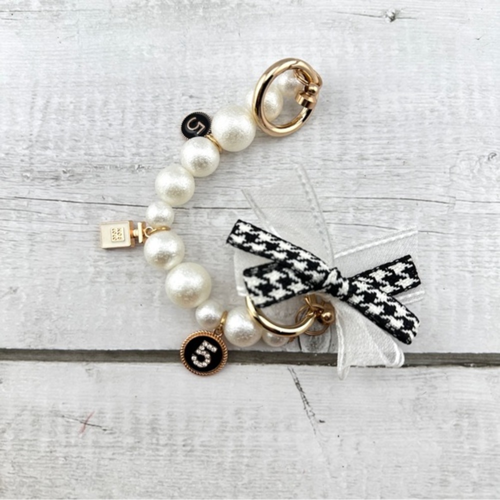 NWOT Brand new keychain with ribbon and gold accents. Black and white.